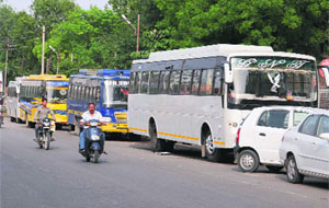 Private buses parked at the roadside near the bus stand in Bathinda on Friday.