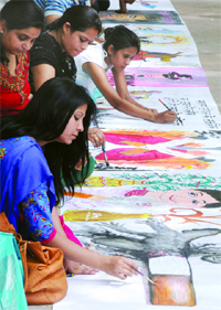 Artists make a painting against tobacco on the occasion of the World No-Tobacco Day, at Jantar Mantar in New Delhi on friday