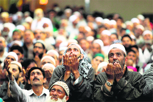 Kashmiri Muslims pray as a head priest displays the holy relic at the Hazratbal shrine in Srinagar on Friday. 