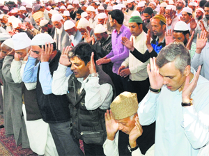 Chief Minister Omar Abdullah and National Conference president Farooq Abdullah along with others offer prayers at the Hazratbal shrine in Srinagar on Friday. 