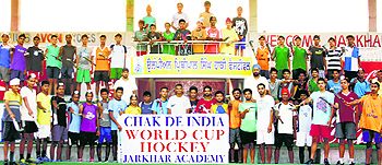 Trainees of Jarkhar Hockey Academy and office-bearers of Mata Sahib Kaur Sports Club wish good luck to Team India for the World Cup, at the main stadium in Jarkhar village