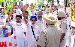 Members of the BKU shout slogans demanding the arrest of the third rape accused outside the IGs residence-cum-office in Bathinda on Saturday
