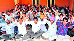 Contractual employees of Punjab State Power Corporation Ltd shout slogans at the Teachers Home in Bathinda on Saturday