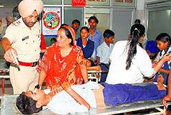 Gurmukh Singh, SHO, Sector 39 police station, talks to the guardian of an injured child at the GMSH, Sector 16, Chandigarh, on Saturday