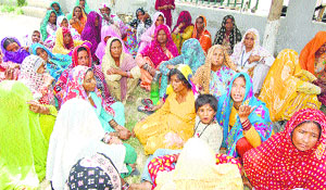 Women from the family of the two teenage girls who died due to a wall collapse at Dhudianwali village, outside the General Hospital in Sirsa on Saturday.
