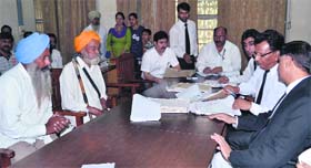 Judicial officials interact with the disputing parties to resolve the cases at  the Lok Adalat at district courts in Jalandhar on Saturday