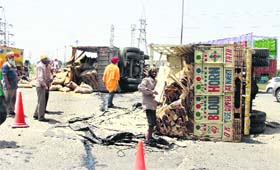 Two loaded trucks overturned on the Jalandhar-Amritsar road, near Chouggiti, on Saturday early morning
