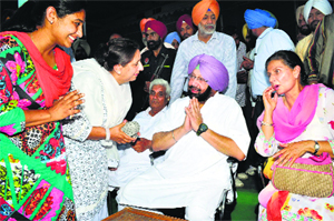 Amritsar MP Amarinder Singh and his wife and former Union State Minister Preneet Kaur with Congress workers at a meeting in Patiala on Sunday. 