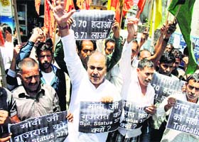 Activists of the Shiv Sena and Dogra Front raise slogans against Article 370, which they want scrapped, in Jammu