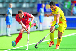 Belgiums John-John Dohmen and Indias VR Raghunath vie for the ball during the Hockey World Cup in The Hague on Saturday