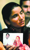 Khalida Bibi, sister of the Farzana Iqbal, holds a picture which according to Bibi is of Farzanas first marriage with her cousin Mazhar Iqbal in Lahore on Saturday. 