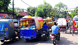 A view of a traffic jam at the level crossing at Ram Bagh in Amritsar; (right) even as the railway crossing is closed, commuters try to get through it
