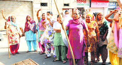 Women of Attawa village, Sector 42, Chandigarh, hold a protest against a liquor vend on Sunday.