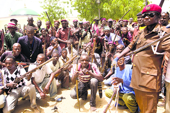A vigilante group of traditional hunters pose for a picture at their camp in Maiduguri.
