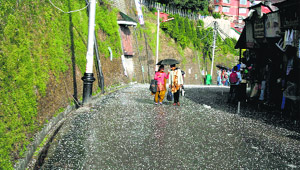 People during a hailstorm in Shimla on Sunday.