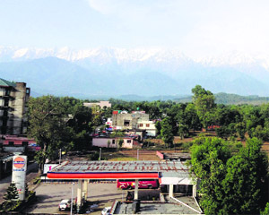 The Dhauladhar mountain range receives fresh snowfall on Sunday.