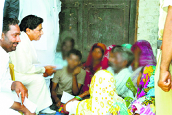 BSP chief Mayawati with victims kin at Katra Shahadatganj village in Badaun on Sunday.