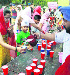 Devotees enjoy sweetened water during a chabeel on the occasion of the martyrdom day of Guru Arjan Dev, in Jalandhar on Sunday.