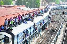 Rush, ride and risk: Students travel atop an overcrowded train to take part in the police constable recruitment exams, at the Jodhpur Railway Station on Sunday