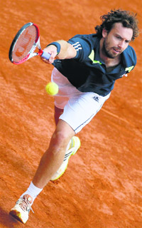 Ernests Gulbis reaches for the ball during the fourth round in French Open on Sunday.