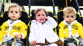 Two-year-old triplet Sarah (C) cries next to her brothers during an annual gathering of twins, triplets and multiplets in Bucharest, Romania