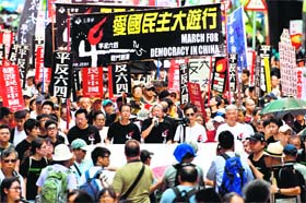 Protesters hold banners and placards as they shout slogans at a rally in Hong Kong ahead of the 25th anniversary of the June 4, 1989 Tiananmen Square crackdown on Sunday