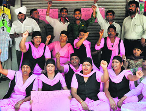 Members of the Nari Jagriti Manch stage a protest against the opening of a liquor vend in Sector 40, Chandigarh, on Monday.