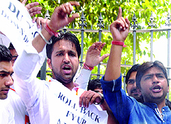 Activists of ABVP shout slogans during a protest outside the VC office at Delhi University in New Delhi on Monday