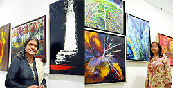 Artists Radha Kumar (L) and Mita Brahma (R) at an exhibition of paintings at Triveni Kala Sangam in New Delhi on Monday