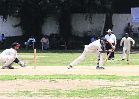 Solid defence: Players in action during the cricket match in Dehradun