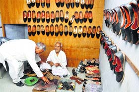 Ambala MP Rattan Lal Kataria seeks blessings from his father Jyoti Ram at the latters shoe shop at Ladwa in Kurukshetra district on Monday