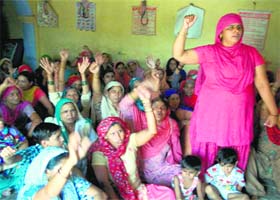 Villagers raise slogans against the police during the panchayat at Ratta Khera village on Monday