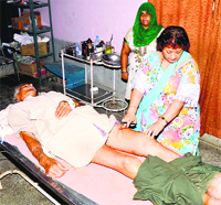Leopard attack victim Kishan Chand receives treatment at the district hospital in Una on Monday.