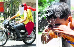 A couple riding a motorcycle cover their faces with a handkerchief and dupatta; and (right) a boy pours water on his head in Jammu.
