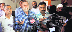 Mohammad Gafoor Dar, a senior leader of the Jammu and Kashmir National Trade Union Front, addresses mediapersons in Jammu on Monday. 