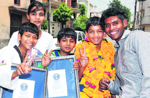 The tae kwon do players in a cheerful mood with their coach in Jalandhar.