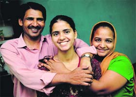 Visually impaired student Samta celebrates her success with her parents in Chandigarh on Tuesday