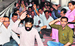 Shiksha Acharyas, who have been agitating for the regularisation of their services for the past two years, hold a dharna in Dehradun on Tuesday.