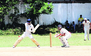 A batsman plays a shot in a match in the All india Uttarakhand Gold Cup Cricket Tournament played at the Rangers College ground in Dehradun on Tuesday.