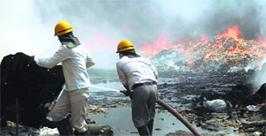 Firefighters douse flames in a godown at Gurgaons Dhanvapur village on Tuesday. The fire broke out due to a short circuit.