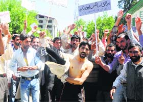 On warpath: Daily wage employees of the state's Public Health Engineering Department hold a protest in support of their demands in Srinagar on Tuesday