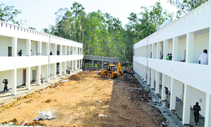 Workers engaged in various tasks to ensure timely completion of construction of the residential school for meritorious students in Ludhiana on Tuesday. 