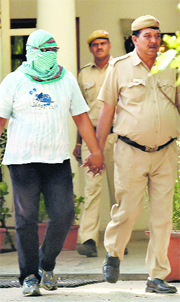 The driver of Indica that hit Union Rural Development Minister Gopinath Mundes car, in police custody in New Delhi.