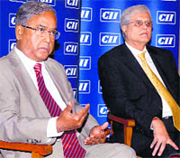 SEBI chairman UK Sinha (L) and CII National Committee on Capital Markets chairman Nimesh Kampani at the CII's 5th Capital Markets Summit in Mumbai on Wednesday.