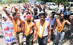 Demanding regular jobs, PGT teachers hold a protest against the state government near Shiksha Sadan in Sector 5, Panchkula, on Wednesday.