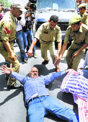A Kashmiri Pandit protests in support of the communitys demands in Srinagar on Wednesday