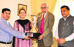 Governor NN Vohra hands over Silver Rolling Trophy to the Principal of the Government College for Women in Srinagar on Wednesday.