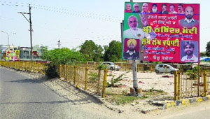 An illegal hoarding with pictures of SAD, BJP leaders on the Fazilka-Delhi national highway at Malout town in Muktsar district on Wednesday.