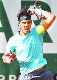 Nadal returns the ball to Ferrer during their quarterfinal match which Nadal won in four sets to reach the semis, on Wednesday. 