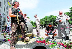 An armed pro-Russian militant guards a barricade outside the regional state building in Lugansk on Wednesday
